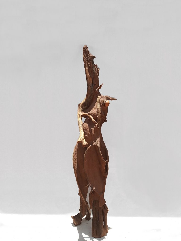 Wangechi Mutu Sentinel I, 2018  Paper pulp, wood glue, concrete, wood, glass beads, stone, rose quartz, gourd, jewelry 87 1/4 x 19 3/4 x 22 in.  Courtesy of the Artist and Gladstone Gallery, New York and Brussels.
