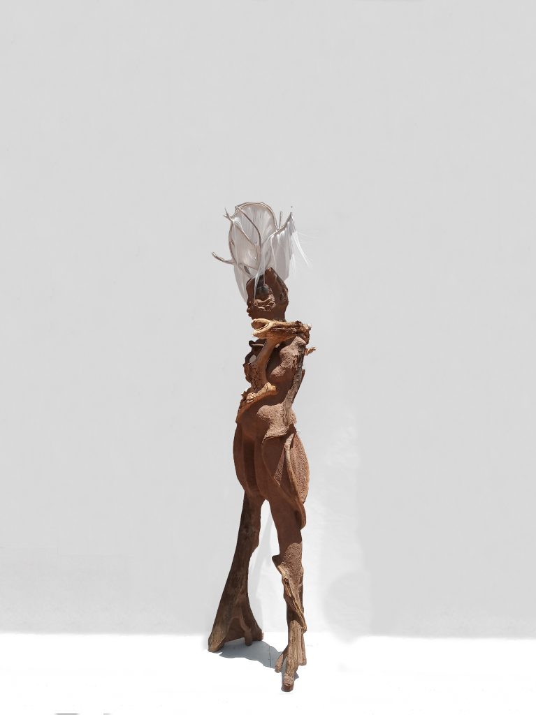 Wangechi Mutu Sentinel II, 2018  Paper pulp, wood glue, concrete, wood, glass beads, stone, rose quartz, gourd, jewelry 87 1/4 x 19 3/4 x 22 in.  Courtesy of the Artist and Gladstone Gallery, New York and Brussels.