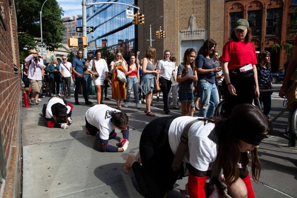 Pope.L, "Conquest," 2019. A group crawl featuring 140 participants, 5-hour duration. Commissioned by Public Art Fund and presented on September 21, 2019 in Downtown Manhattan, New York City © Pope.L Photo credit: Timothy Schenck, courtesy of the artist and Public Art Fund