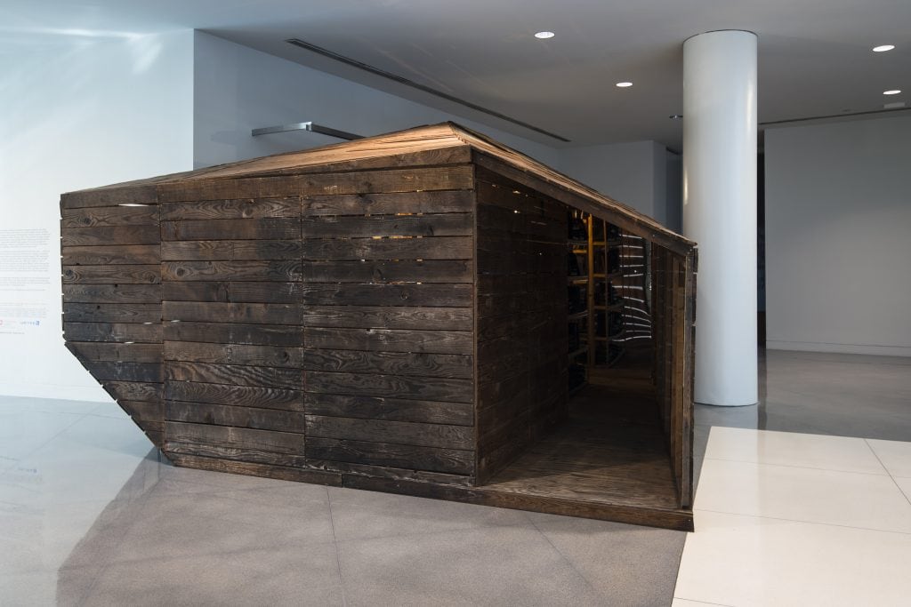 Edgar Arceneaux, "Library of Black Lies", 2016, Wood, mirrored glass, mylar, newspaper, hard-bound books, sugar crystals, lighting fixtures, audio component, Photo credit: Charlie Villyard
