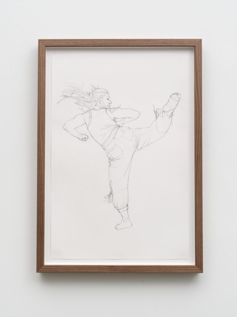 This image depicts an artwork by Andrea Bowers titled "Self-Defense Drawings - Study of Victoriya." This artwork was created in 2021 and measures 22 ³⁄₈" x 15" [HxW] (56.81 x 38.1 cm) paper size; 25 ¹⁄₄" x 17 ³⁄₄" x 2" [HxWxD] (64.13 x 45.08 x 5.08 cm) framed. Its medium is Graphite on paper.