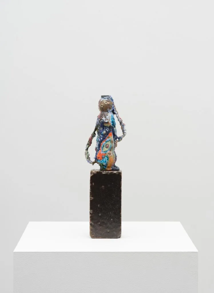 This image depicts an artwork by Tam Van Tran titled "Queen of Spring I." This artwork was created in 2024 and measures 17" x 5" x 2 ¹⁄₂" [HxWxD] (43.18 x 12.7 x 6.35 cm). Its medium is Stoneware sculpture on glazed terra cotta brick.