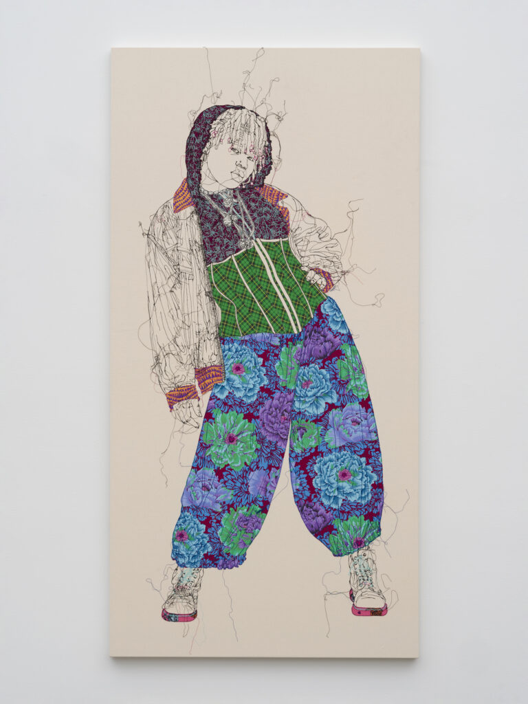 This image depicts an artwork by Gio Swaby titled "As We Are: Zaneta." This artwork was created in 2025 and measures 83" x 42" x 1 ¹⁄₂" [HxWxD] (210.82 x 106.68 x 3.81 cm). Its medium is Cotton fabric and cotton thread stitched onto canvas.