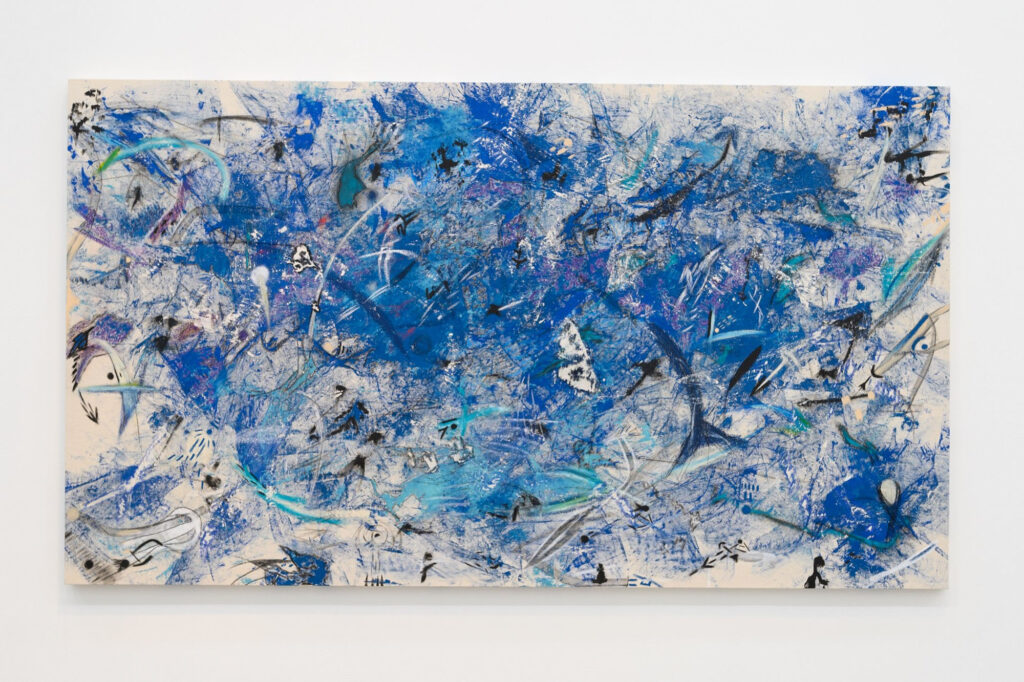 This image depicts an artwork by Muna Malik titled "Minefield." This artwork was created in 2021 and measures 57" x 100" [HxW] (144.78 x 254 cm). Its medium is Acrylic oil pastel charcoal and chalk on canvas.
