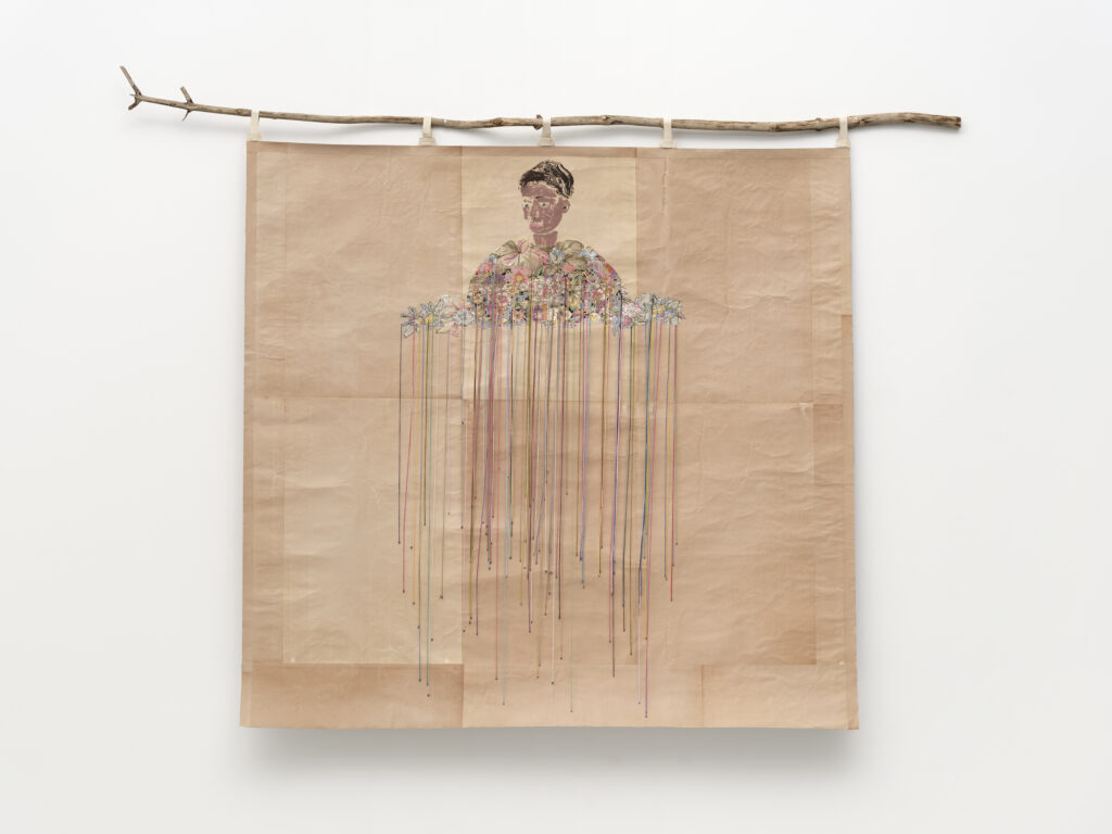 This image depicts an artwork by Lyne Lapointe titled "The Gardener." This artwork was created in 2025 and measures 61 ¹⁄₂" x 84" x 2 ¹⁄₂" [HxWxD] (156.21 x 213.36 x 6.35 cm). Its medium is Ink on papier d’Arménie, linen, antique tapestry, embroidery thread, wooden branch and little lead weight.