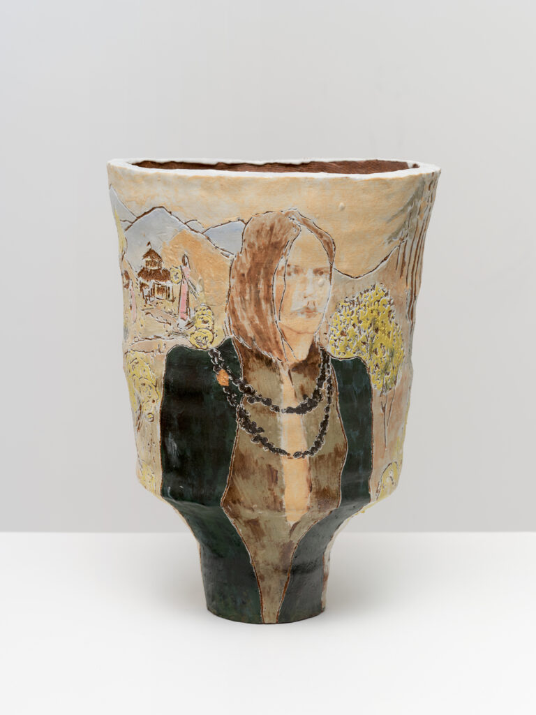 This image depicts an artwork by Shanna Waddell titled "Sheness walks the lands of Sheness Society." This artwork was created in 2025 and measures 15 ³⁄₈" x 10 ⁵⁄₈" x 10 ⁵⁄₈" [HxWxD] (39.07 x 27 x 27 cm). Its medium is Ceramic, Underglaze.