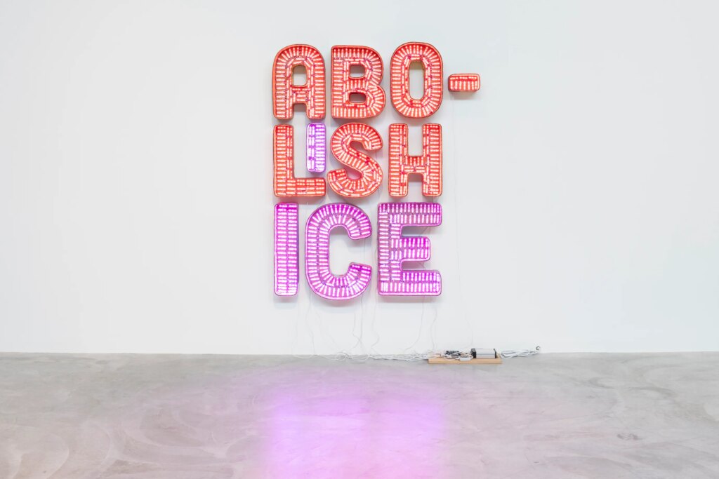 This image depicts an artwork by Andrea Bowers titled "Abolish ICE." This artwork was created in 2018 and measures 84" x 68 ¹⁄₂" [HxW] (213.36 x 173.99 cm). Its medium is Cardboard, LED lights.