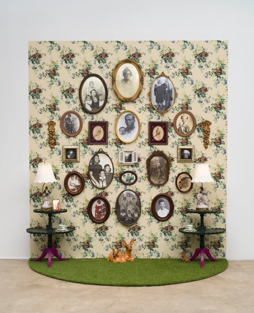 This image depicts an artwork by Genevieve Gaignard titled "Family Tree." This artwork was created in 2022 and measures 10'  x 9' ¹⁄₂" x 54" [HxWxD] (304.8 x 275.59 x 137.16 cm). Its medium is Mixed media, vintage wallpaper.