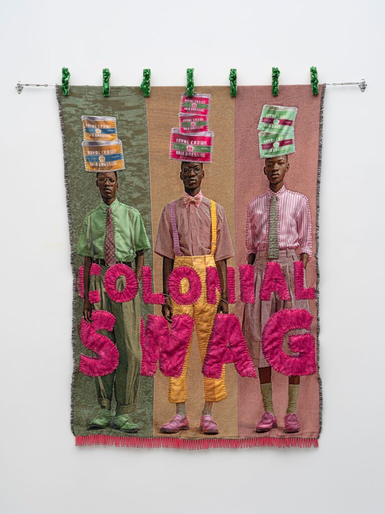 This image depicts an artwork by April Bey titled "Winning without Trying but Can We Win without Dying?." This artwork was created in 2026 and measures 80" x 60" [HxW] (203.2 x 152.4 cm). Its medium is Jacquard textiles, hand-sewn sherpa fabric, adorned jumbo clothespins, ponytail beads.